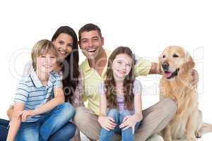 Family with golden retriever against white background