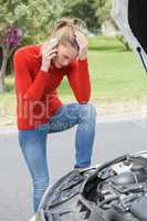 Stressed woman looking at engine