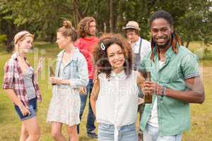 Happy friends in the park having barbecue