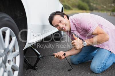 Man changing wheel after a car breakdown