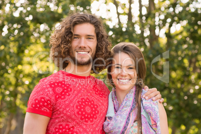 Friends smiling at camera in the park