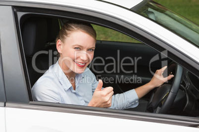 Smiling businesswoman sitting in drivers seat