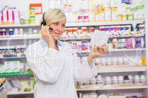 Pharmacist with headphone reading a prescription