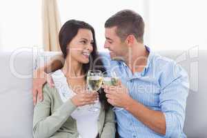 Loving couple toasting wine glasses