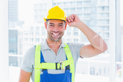 Happy manual worker wearing yellow hard hat