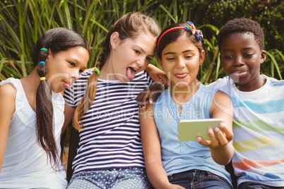 Happy children taking selfie at park