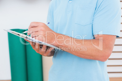 Trainer writing on clipboard