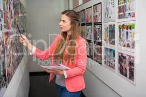 Creative businesswoman pointing at photos