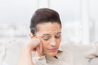 Woman relaxing with eyes closed on sofa