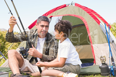 Father and son by their tent Father and son by their tent