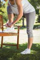 Fit woman tying her shoelace