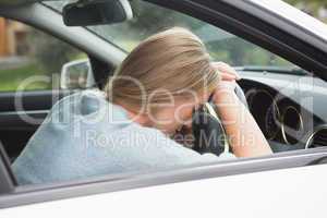 Tired woman asleep on steering wheel