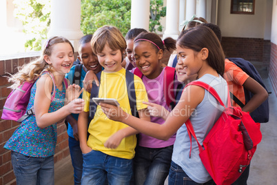 Cute pupils using mobile phone