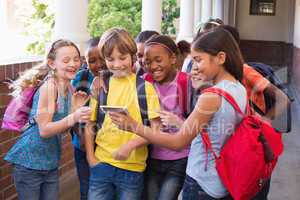 Cute pupils using mobile phone