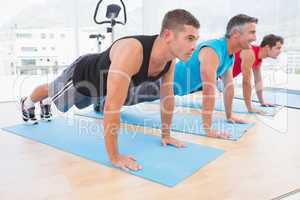 Group of men working on exercise mat