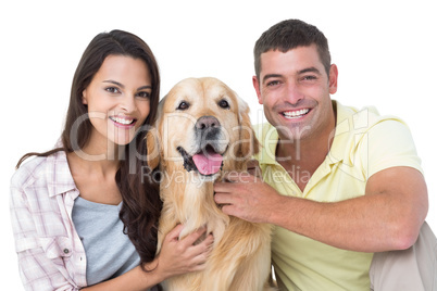 Happy loving couple stroking dog