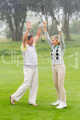 Excited golfing couple cheering Excited golfing couple cheering