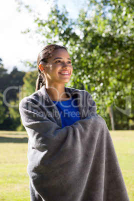 Pretty woman wrapped in blanket