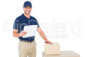 Happy delivery man with cardboard boxes and clipboard