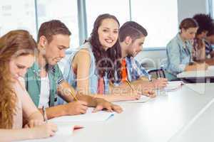 Fashion student smiling at camera in class