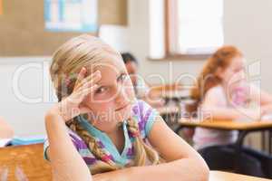 Thoughtful pupil sitting at his desk