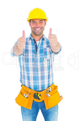 Happy repairman gesturing thumbs on white background