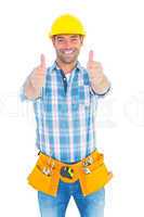 Happy repairman gesturing thumbs on white background