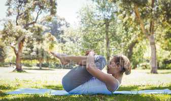 Fit woman doing yoga in the park