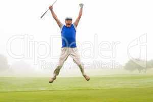 Excited golfer jumping up and smiling at camera
