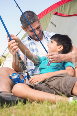 Father and son beside tent