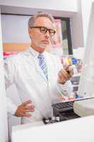 Senior pharmacist using the computer