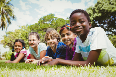 Portrait of happy children lying on grass