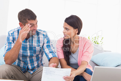 Stressed couple discussing over home finances