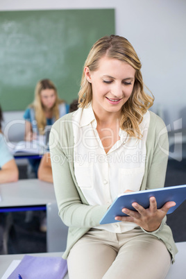 Female teacher using digital tablet in class