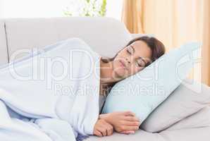 Young woman sleeping on sofa