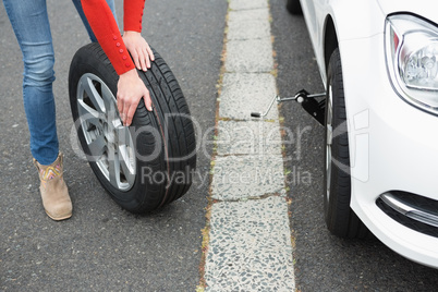 Woman replacing tire