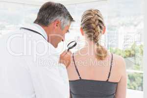 Doctor examining a spot at his patient