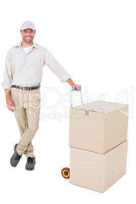 Confident delivery man with cardboard boxes