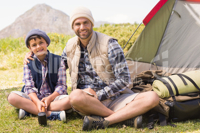 Father and son beside their tent