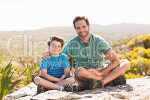 Father and son hiking through mountains