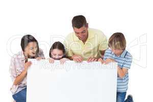 Family of four looking at billboard