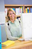 Pretty librarian smiling at camera