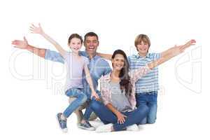 Happy family with arms outstretched over white background