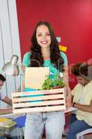 Casual businesswoman carrying her belongings in box