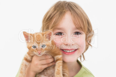 Close-up portrait of cute boy holding kitten