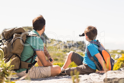 Father and son hiking through mountains