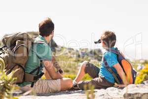 Father and son hiking through mountains