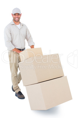 Happy delivery man pushing trolley of boxes Happy delivery man pushing trolley of boxes