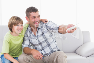 Happy father and son using remote control