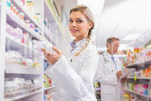 Smiling student holding medicine